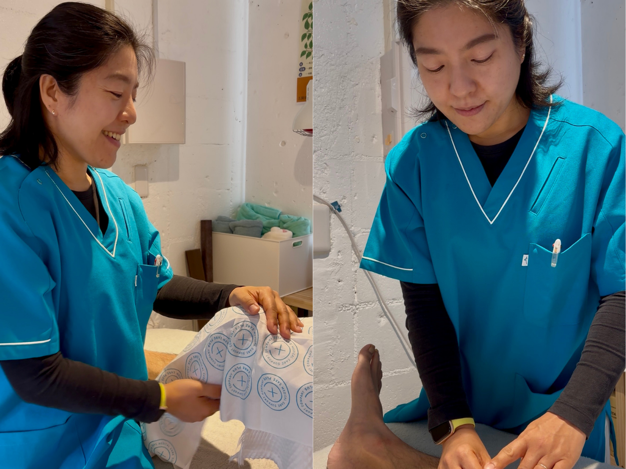 Healthcare workers in teal scrubs examining stamped documents together in a clinical setting